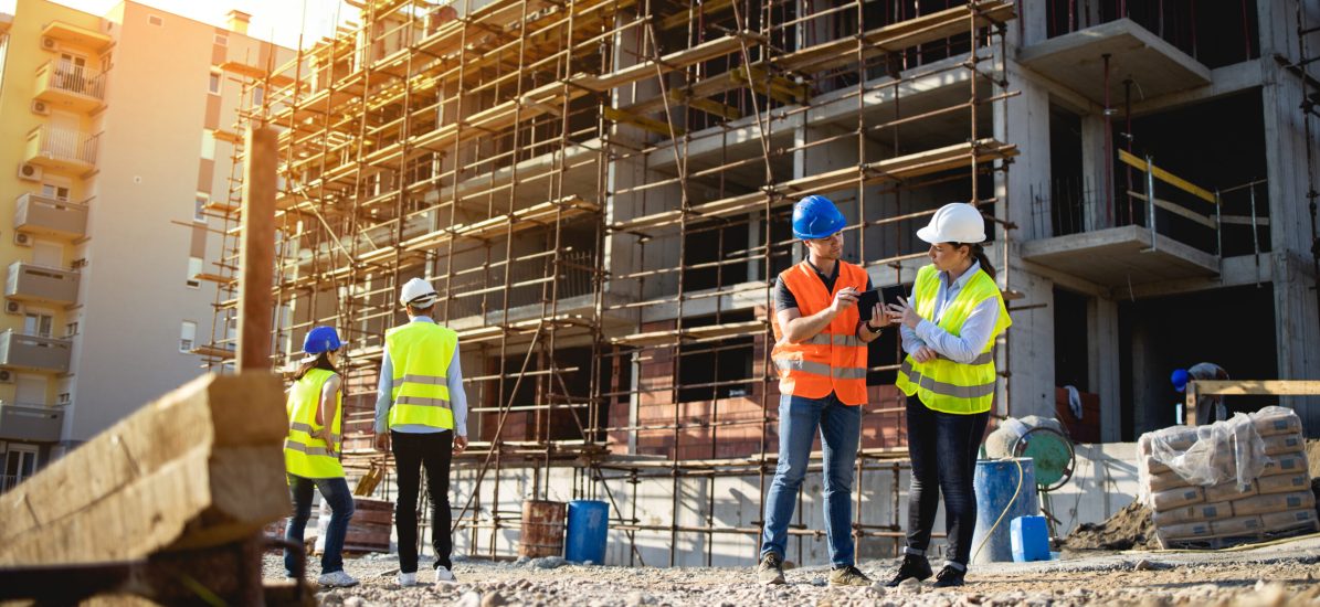 Four construction workers having meeting,stock photo